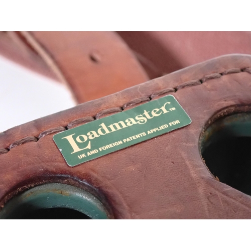 468 - A leather covered Loadmaster Loader's Cartridge Magazine and another covered in canvas