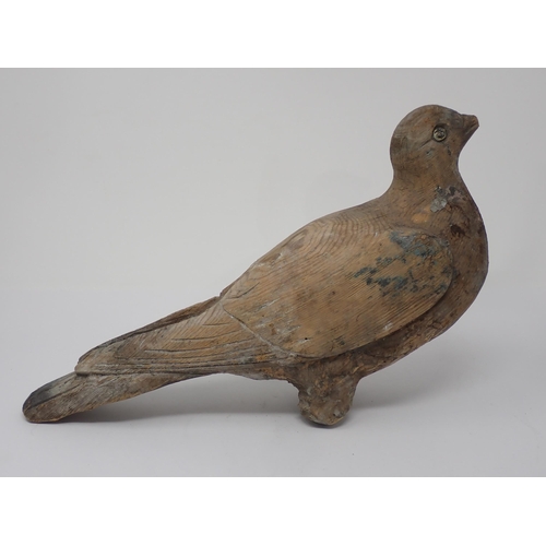 492 - An antique well carved Pigeon Decoy with scapular, covert, primary and retrices detail and paint rem... 