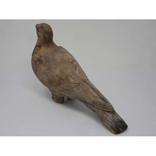 492 - An antique well carved Pigeon Decoy with scapular, covert, primary and retrices detail and paint rem... 