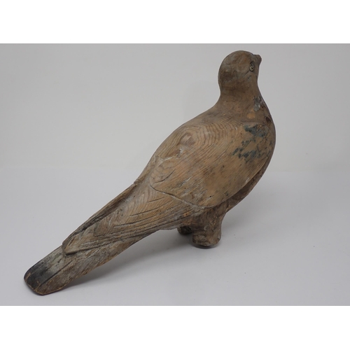 492 - An antique well carved Pigeon Decoy with scapular, covert, primary and retrices detail and paint rem... 