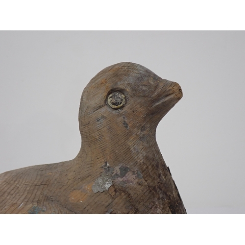 492 - An antique well carved Pigeon Decoy with scapular, covert, primary and retrices detail and paint rem... 