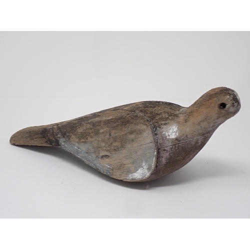 493 - An antique carved Pigeon Decoy with carved shoulders and primaries, some paint remnants, lacking eye... 