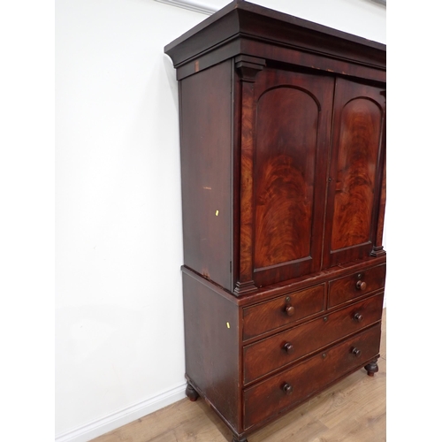 1 - A Victorian mahogany Linen Press the upper section fitted pair of arched doors above base of two sho... 