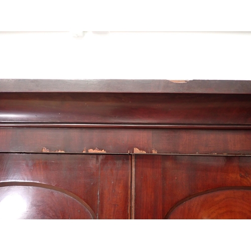 1 - A Victorian mahogany Linen Press the upper section fitted pair of arched doors above base of two sho... 