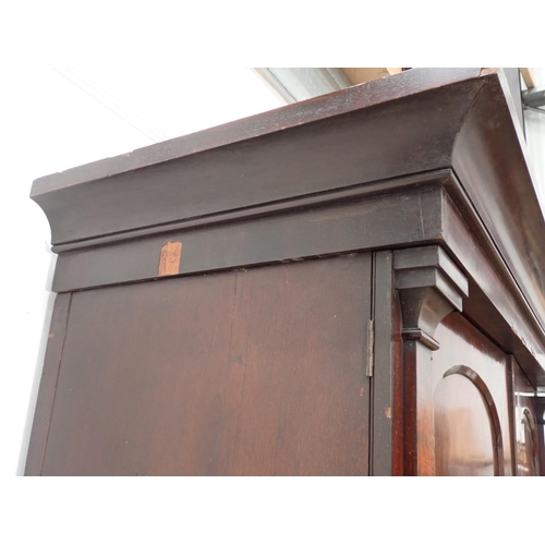 1 - A Victorian mahogany Linen Press the upper section fitted pair of arched doors above base of two sho... 