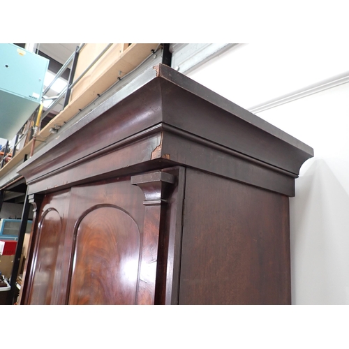 1 - A Victorian mahogany Linen Press the upper section fitted pair of arched doors above base of two sho... 