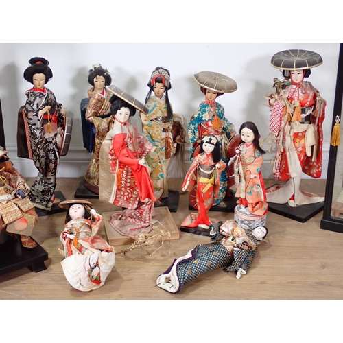 240 - A collection of Chinese Costume Dolls including two in display cases