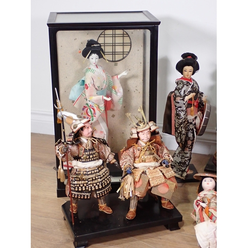 240 - A collection of Chinese Costume Dolls including two in display cases