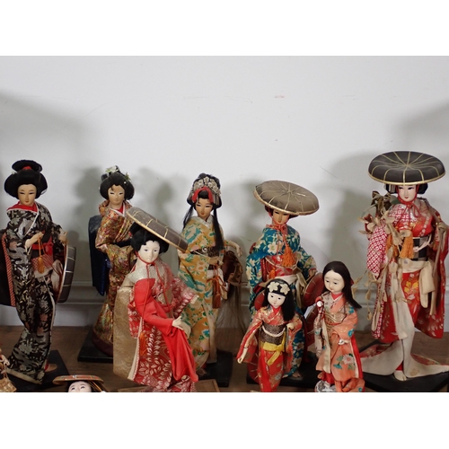 240 - A collection of Chinese Costume Dolls including two in display cases