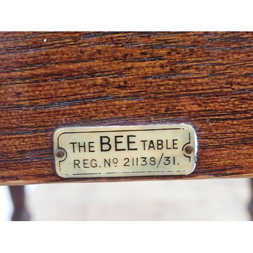 246 - An oak folding top Dining Table bearing label 'The Bee Table' and three slat back Kitchen Chairs