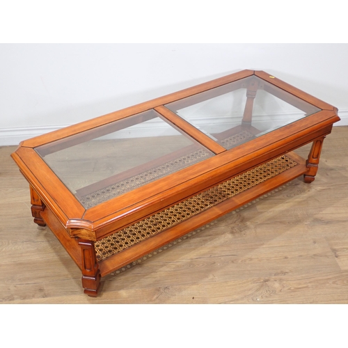 251 - A glass top Coffee Table on shaped squared supports, and cane panelled lower tier, 4ft 5in W