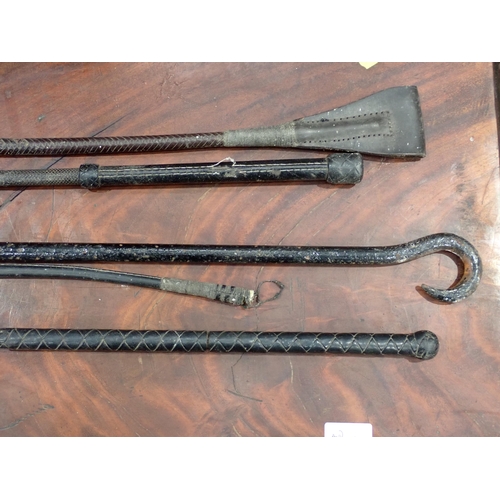 281 - Three various Riding Crops and a metal Bar with hook