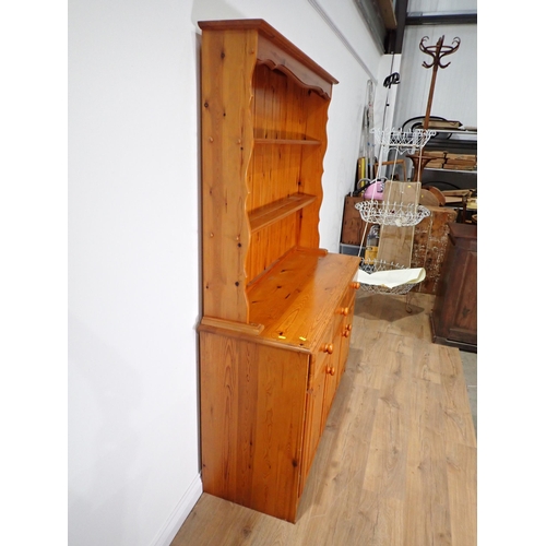 303 - A modern pine Kitchen Dresser and Rack the base fitted three frieze drawers above three cupboard doo... 