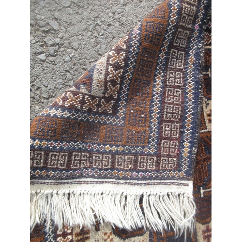 306 - A modern beige ground Rug with three navy stylised flower heads within multiple borders 6ft 6in L x ... 