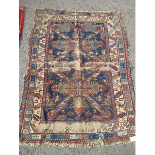 307 - An old blue ground Persian Rug with geometric design within multiple borders A/F 5ft 4in L x 3ft 9in... 