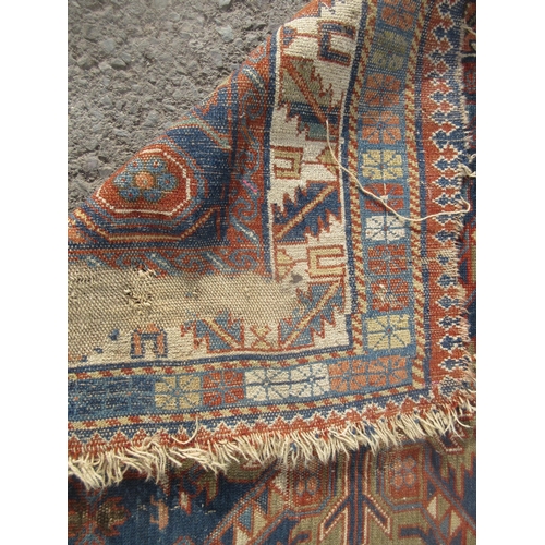 307 - An old blue ground Persian Rug with geometric design within multiple borders A/F 5ft 4in L x 3ft 9in... 