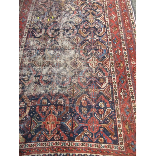 308 - An old Persian Rug with deep blue centre with stylised floral design with multiple borders 8ft 8in L... 