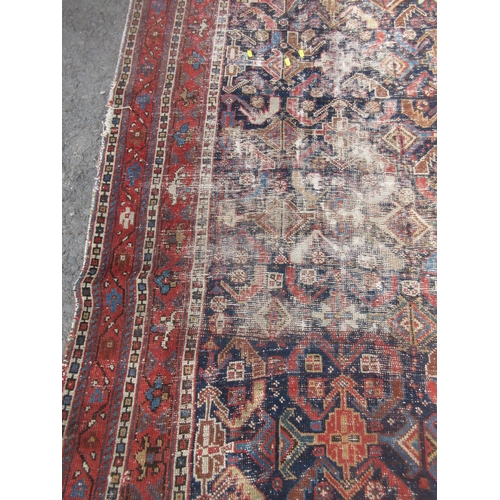 308 - An old Persian Rug with deep blue centre with stylised floral design with multiple borders 8ft 8in L... 