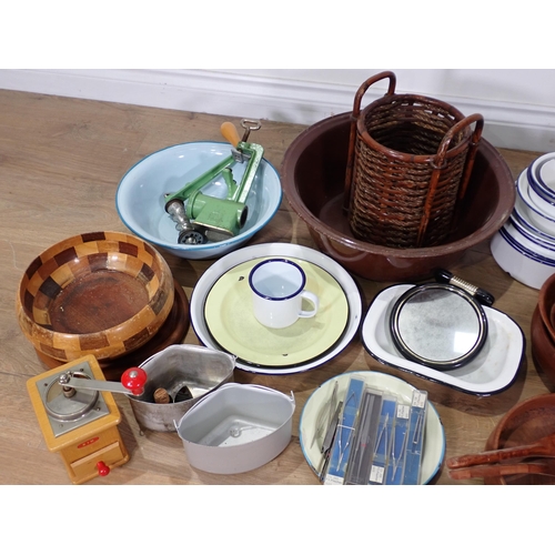 320 - A quantity of Kitchenalia including enamel Bowls, meat Plates, wooden Bowls and three large metal Pa... 