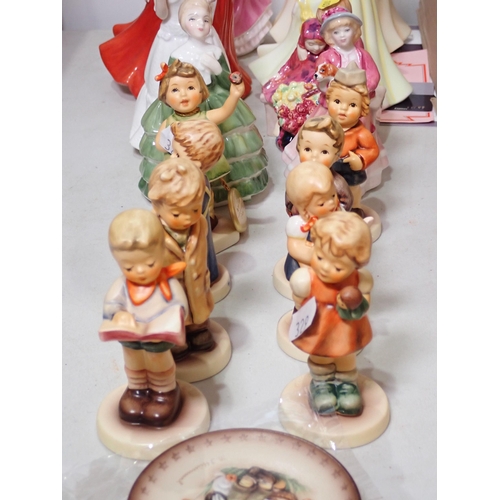 329 - A small collection of Hummel Figurines, Doulton ladies etc