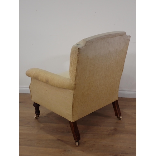 445 - A 19th Century yellow upholstered Armchair on turned mahogany front supports