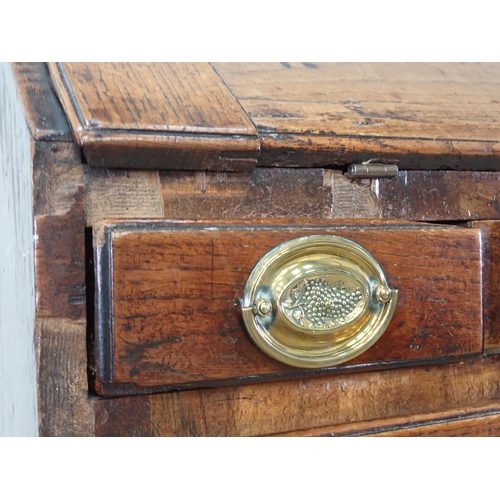 452 - A Georgian oak Bureau with fall front enclosing fitted interior above five short and two long drawer... 