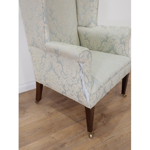 472 - A 19th Century wingback Armchair on square cut tapering supports and casters