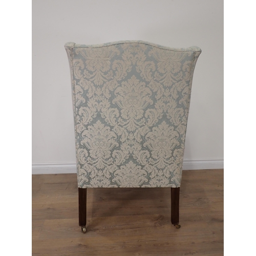 472 - A 19th Century wingback Armchair on square cut tapering supports and casters