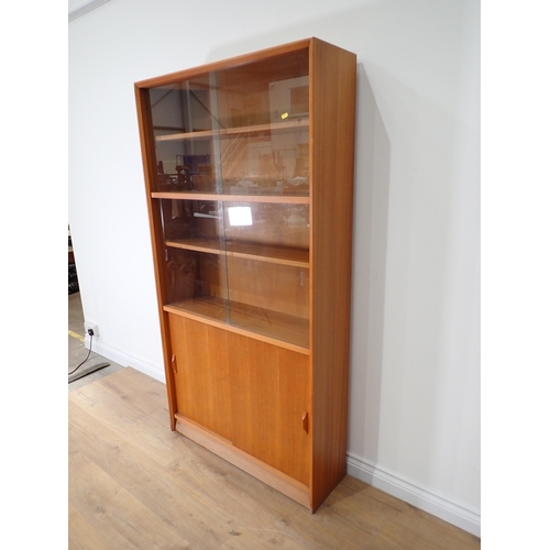 513 - A modern Bookcase with sliding glass doors 5ft 8in H x 3ft W