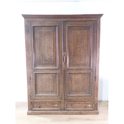 516 - An 18th Century and later joined oak Press Cupboard fitted pair of fielded panel doors above two dra... 