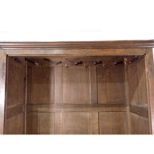 516 - An 18th Century and later joined oak Press Cupboard fitted pair of fielded panel doors above two dra... 