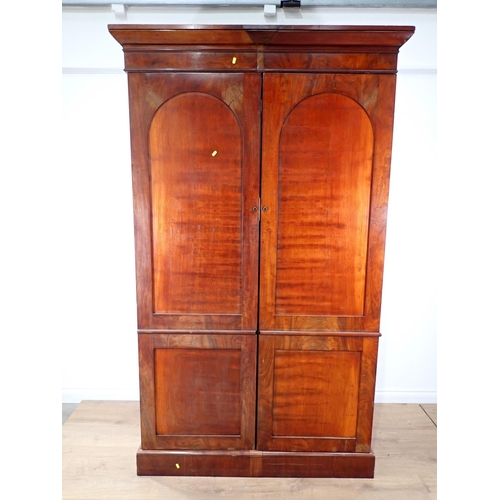 519 - A 19th Century mahogany Wardrobe fitted pair of arched panel doors on plinth base 7ft 3in H x 4ft 5i... 