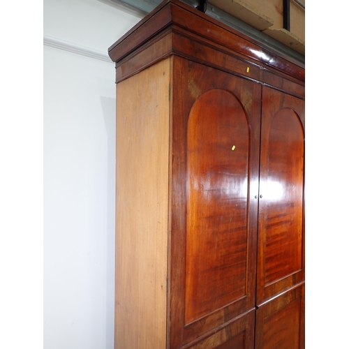 519 - A 19th Century mahogany Wardrobe fitted pair of arched panel doors on plinth base 7ft 3in H x 4ft 5i... 