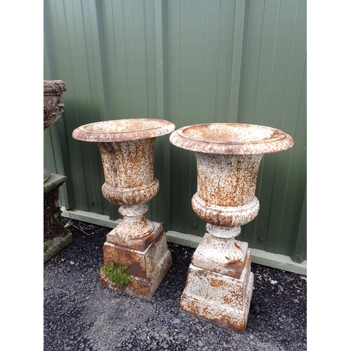 541 - A pair of antique cast iron Urns on plinths 2ft 3in H