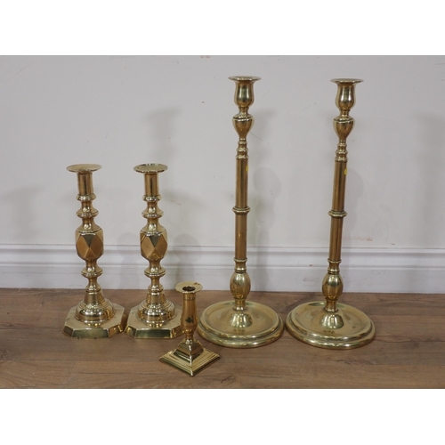 59 - A pair of 19th Century star Candlesticks, a tall pair of brass Candlesticks, a short brass Candlesti... 