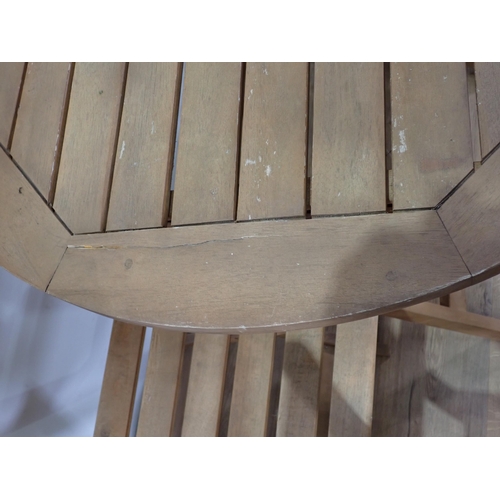 62 - A circular wooden Garden Table and four Chairs