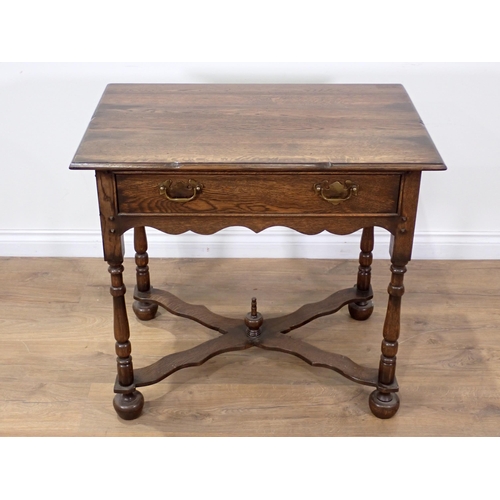 65 - An 18th Century style oak Side Table fitted single frieze drawer on turned supports with shaped X-st... 