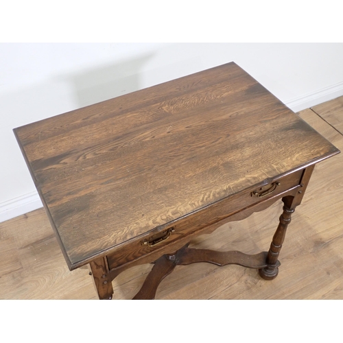 65 - An 18th Century style oak Side Table fitted single frieze drawer on turned supports with shaped X-st... 