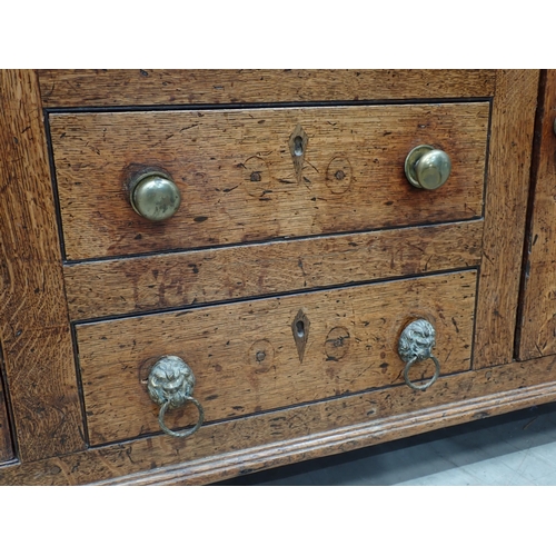 558 - A George III oak enclosed Dresser and Rack fitted three frieze drawers above pair of Cupid's bow car... 