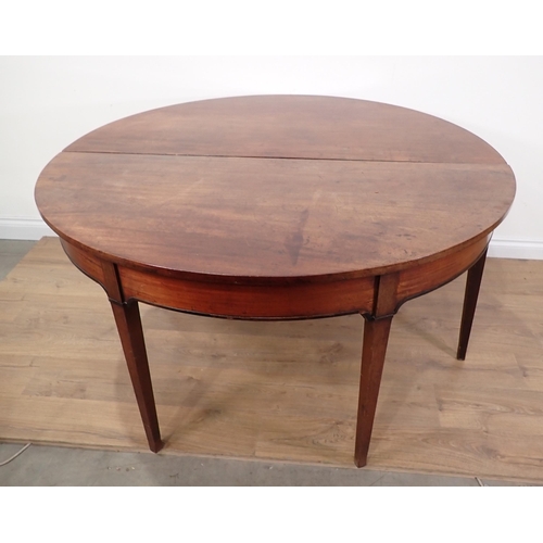 558A - A Georgian mahogany dropleaf circular Dining Table on square cut tapering supports 4ft 6in D x 2ft 4... 