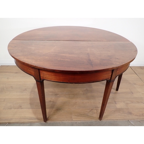 558A - A Georgian mahogany dropleaf circular Dining Table on square cut tapering supports 4ft 6in D x 2ft 4... 