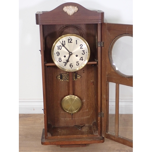 104 - An oak cased Wall Clock