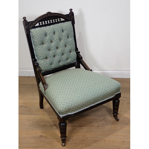 109 - A Victorian ebonised blue upholstered button back Nursing Chair