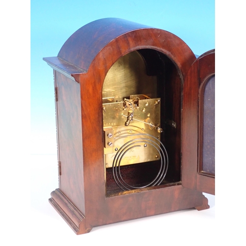 112 - A walnut cased Mantle Clock with arched brass dial 10 1/2in H