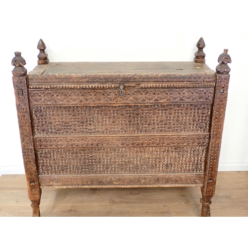 121 - An Indian carved hardwood Chest of large proportions with hinged lid 4ft 6in W x 4ft 5in H