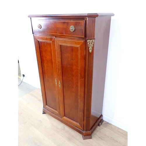 14 - A mahogany veneered two door Cupboard fitted single drawer above 4ft 6in H x 2ft 10in W