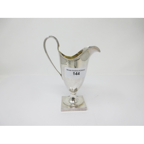 144 - A modern silver helmet shape Cream Jug on square base, London 1978