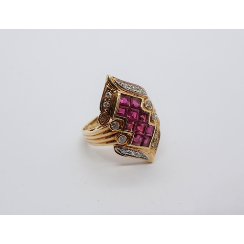 156 - A Ruby and Diamond Cocktail Ring having lozenge shaped plaque invisibly-set ten calibre-cut rubies w... 