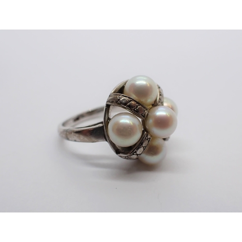 167 - A Cultured Pearl Cluster Ring set five pearls in white gold stamped 18K, ring size K 1/2