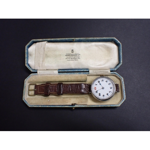 184 - A WWI Wristwatch the white enamel dial with black arabic numerals and red 12 in steel case on leathe... 